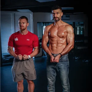 Christian Williams standing next to a fit client, showcasing transformation results and muscular definition.