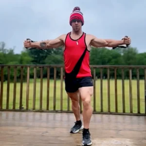 Christian Williams training outdoors using resistance bands, focusing on upper body activation