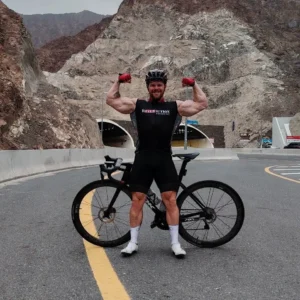 Coach Christian Williams showcasing strength and endurance in cycling, demonstrating how L-Arginine supports performance and sustained power output